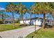 Large side yard with spacious driveway and mature landscaping at 2418 Frantz St, North Port, FL 34286