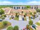 Aerial view of townhouses with garages and lush landscaping at 25188 Marion Ave # 1011, Punta Gorda, FL 33950