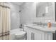 Clean bathroom with a bathtub, toilet and granite countertop vanity at 25188 Marion Ave # 1011, Punta Gorda, FL 33950