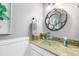 Modern bathroom with a glass sink, granite countertop, and decorative mirror at 25188 Marion Ave # 1011, Punta Gorda, FL 33950