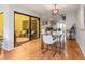 Bright dining area with glass table and chairs, view into the kitchen and patio at 25188 Marion Ave # 1011, Punta Gorda, FL 33950