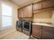 Laundry room with washer, dryer, and ample cabinet space at 2521 Rio Grande Dr, Punta Gorda, FL 33950