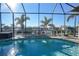 Inviting swimming pool with waterfall feature and screened enclosure at 2521 Rio Grande Dr, Punta Gorda, FL 33950