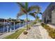 Brick-paved walkway along the canal with lush landscaping at 2521 Rio Grande Dr, Punta Gorda, FL 33950