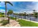 Private backyard with canal access, dock, and lush landscaping at 2730 Rio Ct, Punta Gorda, FL 33950