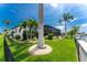 Landscaped backyard with palm trees and canal views at 2730 Rio Ct, Punta Gorda, FL 33950