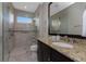 Bathroom boasts a walk-in shower, granite countertop, and large mirror at 2730 Rio Ct, Punta Gorda, FL 33950