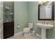 Powder room with pedestal sink and dark wood vanity at 2730 Rio Ct, Punta Gorda, FL 33950