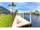 Concrete dock with chain link fence and steps at 2730 Rio Ct, Punta Gorda, FL 33950