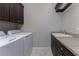 Bright laundry room with washer, dryer, and ample cabinetry at 2730 Rio Ct, Punta Gorda, FL 33950