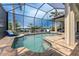 Enclosed pool and spa with lounge chairs and canal view at 2730 Rio Ct, Punta Gorda, FL 33950