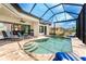 Enclosed pool and spa with lounge chairs and canal view at 2730 Rio Ct, Punta Gorda, FL 33950