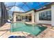 Enclosed pool and spa with lounge chairs and canal view at 2730 Rio Ct, Punta Gorda, FL 33950