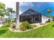 Lush landscaping surrounds the screened pool area at 2730 Rio Ct, Punta Gorda, FL 33950