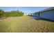 Large backyard with grassy area and a patio at 282 Seminole Nw Blvd, Port Charlotte, FL 33952