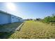 Large backyard with grassy area and a patio at 282 Seminole Nw Blvd, Port Charlotte, FL 33952