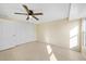 Bright bedroom with tile flooring, double closets, and ceiling fan at 282 Seminole Nw Blvd, Port Charlotte, FL 33952