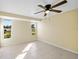 Spacious bedroom with tile flooring, ceiling fan, and large windows at 282 Seminole Nw Blvd, Port Charlotte, FL 33952