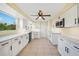 Bright kitchen with white cabinets, quartz countertops, and stainless steel appliances at 282 Seminole Nw Blvd, Port Charlotte, FL 33952