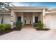 Inviting front entrance with covered porch and lush landscaping at 2856 Deborah Dr, Punta Gorda, FL 33950