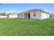 Newly built home with a spacious backyard and grassy lawn at 3334 Levee St, North Port, FL 34288