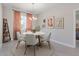 Bright dining room features a round table with four chairs and modern light fixture at 3334 Levee St, North Port, FL 34288