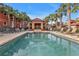 Resort-style pool with a covered patio and lounge chairs at 3500 Mondovi Ct # 212, Punta Gorda, FL 33950