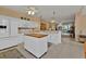 Bright kitchen with white cabinetry, kitchen island, and stainless steel appliances at 3500 Mondovi Ct # 212, Punta Gorda, FL 33950