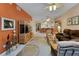 Living room with wicker furniture and orange wall at 3500 Mondovi Ct # 212, Punta Gorda, FL 33950