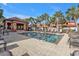 Community pool with lounge chairs and shaded seating at 3500 Mondovi Ct # 212, Punta Gorda, FL 33950