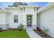 Modern front entrance with a black door and stone accents at 4024 Feather Ter, North Port, FL 34286