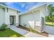 Modern front entrance with a black door and stone accents at 4024 Feather Ter, North Port, FL 34286