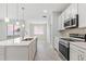 Modern kitchen with white cabinets, island, and stainless steel appliances at 4024 Feather Ter, North Port, FL 34286