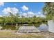 Charming waterfront dock with a table and rug for enjoying the view at 4118 Gardner Dr, Port Charlotte, FL 33952