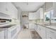 Modern white kitchen with updated appliances and light colored cabinets at 4118 Gardner Dr, Port Charlotte, FL 33952