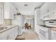 Clean and bright kitchen, featuring white cabinets and a view into the dining area at 4118 Gardner Dr, Port Charlotte, FL 33952