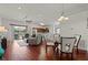 Open concept dining area with glass table and white chairs at 4465 Kaskin Ave, North Port, FL 34286