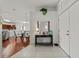 Bright and airy entryway with tile flooring, console table, and view into the dining area at 4465 Kaskin Ave, North Port, FL 34286