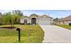 Tan house with a white garage door and palm trees in the front yard at 4465 Kaskin Ave, North Port, FL 34286