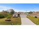 Front view of house featuring a driveway and palm trees at 4465 Kaskin Ave, North Port, FL 34286