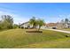 House with a two-car garage and palm trees at 4465 Kaskin Ave, North Port, FL 34286