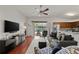 Living room with hardwood floors, gray sofa, and view of the pool at 4465 Kaskin Ave, North Port, FL 34286