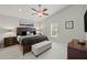 Spacious main bedroom with king-size bed, ceiling fan, and ensuite bathroom at 4465 Kaskin Ave, North Port, FL 34286