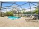 Enclosed pool area with patio and lounge chairs at 4465 Kaskin Ave, North Port, FL 34286