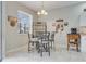 Breakfast nook with glass-top table and four chairs, adjacent to kitchen at 4557 Sabrina Ter, North Port, FL 34286