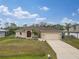 Tan one story house with red door and two car garage at 4557 Sabrina Ter, North Port, FL 34286