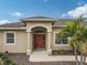 Front entry with red door, columns and landscaping at 4557 Sabrina Ter, North Port, FL 34286