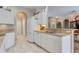 Kitchen boasts white cabinets, corian countertops, and stainless steel appliances at 4557 Sabrina Ter, North Port, FL 34286