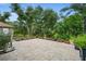 Landscaped backyard with spacious patio and mature trees at 5208 Griggs Ave, North Port, FL 34291