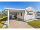 Inviting mobile home exterior featuring a carport and well-maintained landscaping at 5298 Palena Blvd, North Port, FL 34287